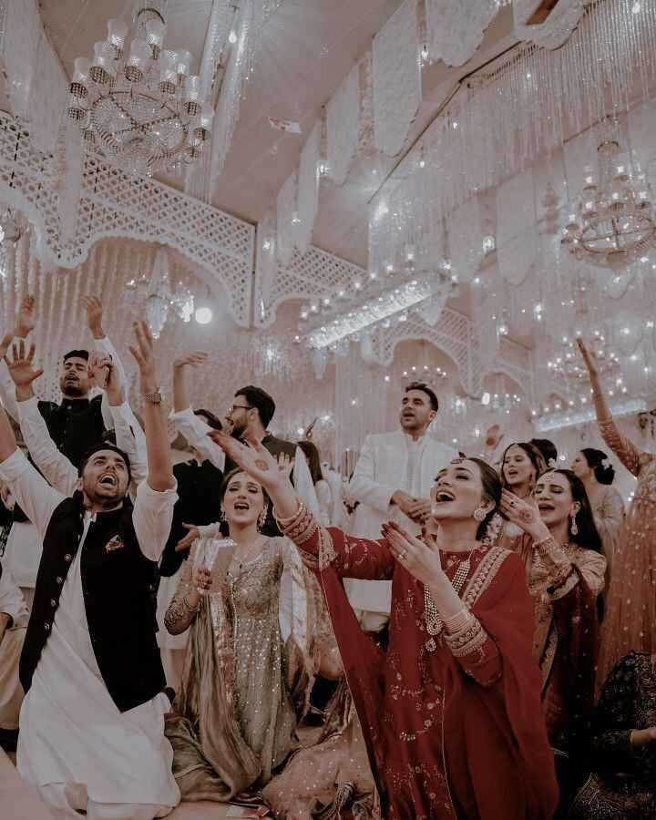 Joyful wedding celebration with guests dancing in traditional attire under elegant decor, captured by the best wedding planner Kochi – Al Ameen Wedding Services.